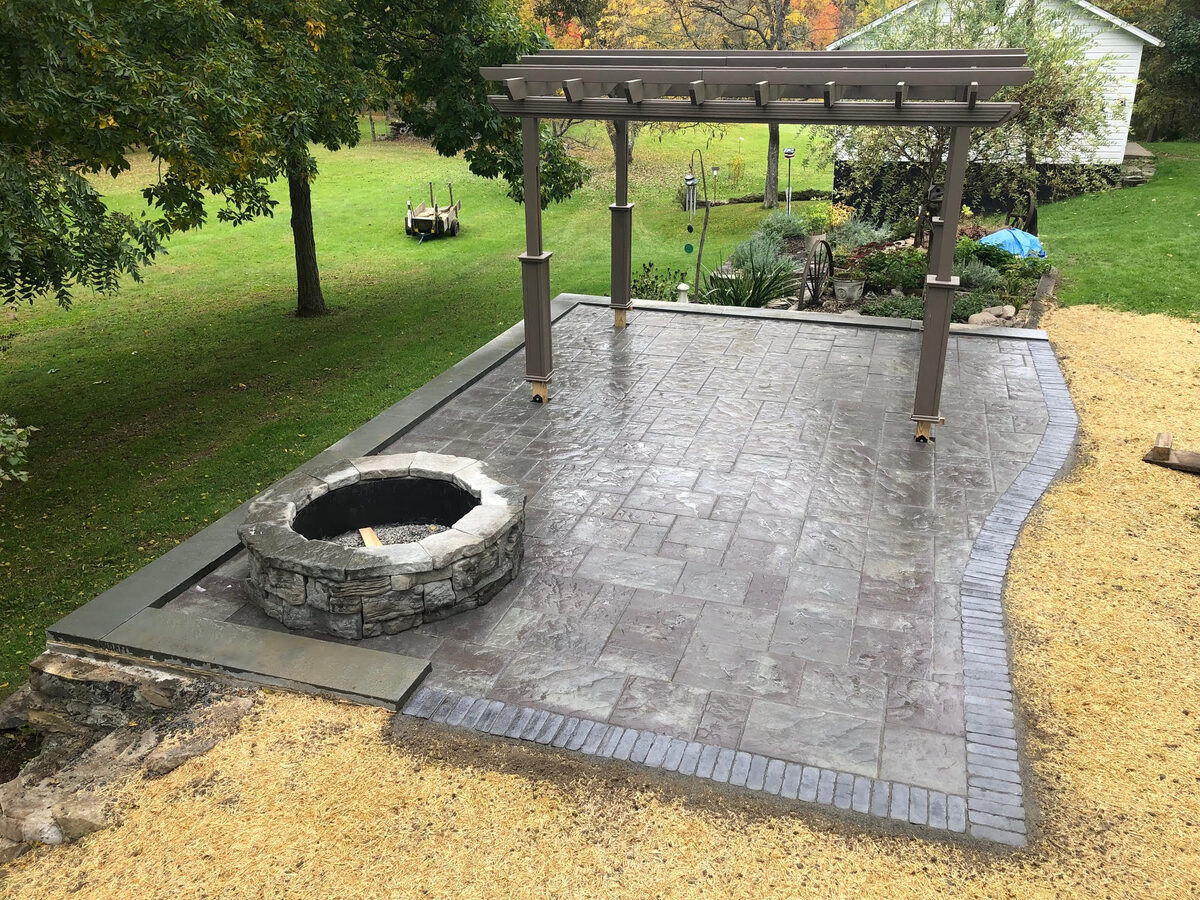 Patio installation with pergola and fire pit